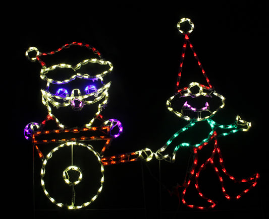 Elf Pulling Santa Claus in Cart